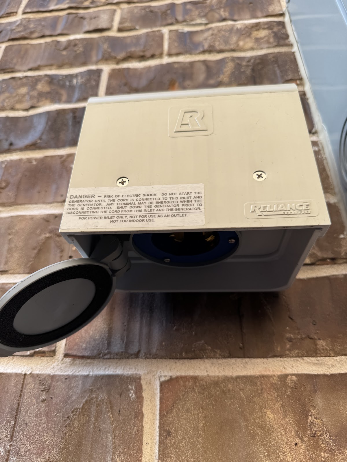 Completed Reliance Controls generator power inlet box on brick wall